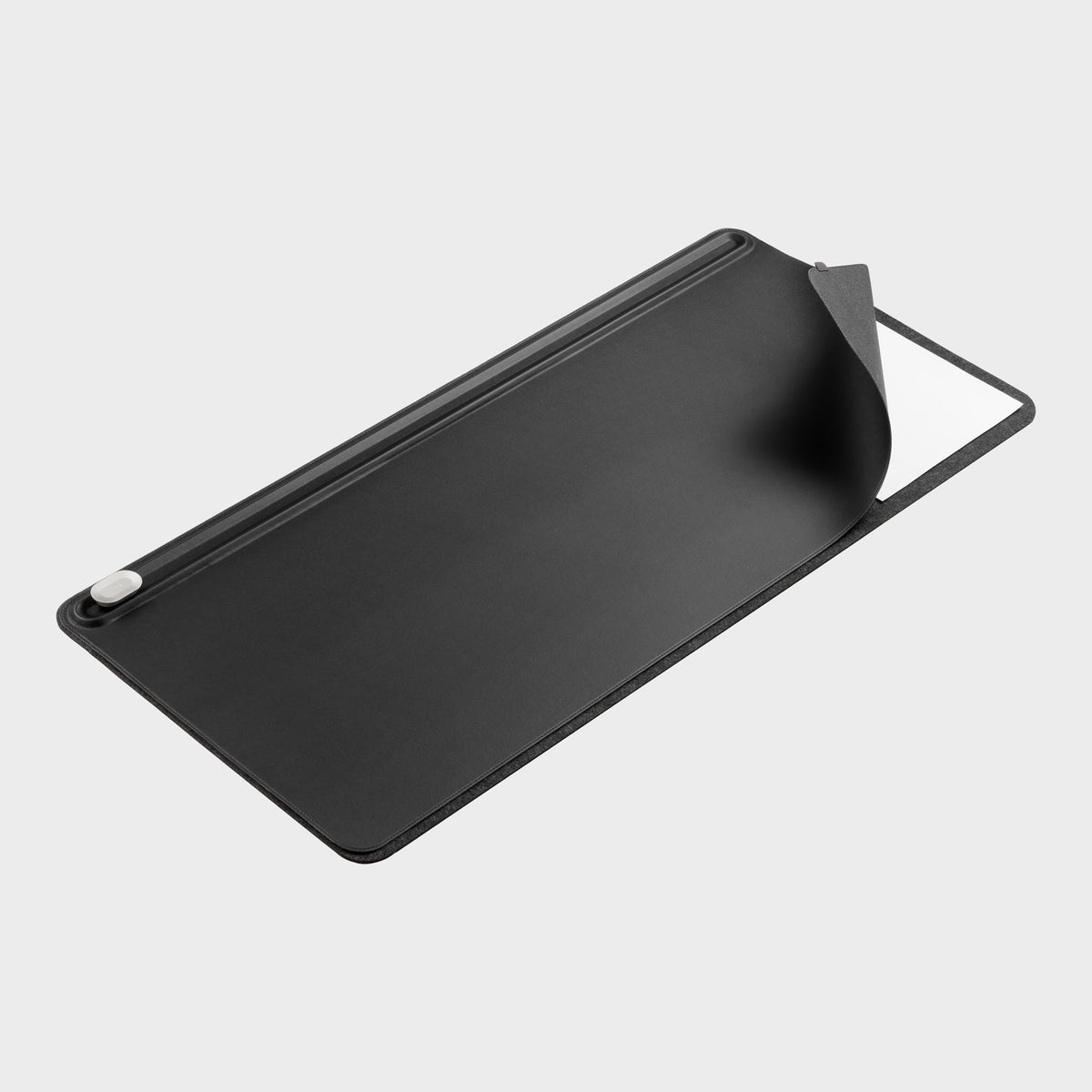 A premium desk mat styled with a notebook, keyboard, and pen.